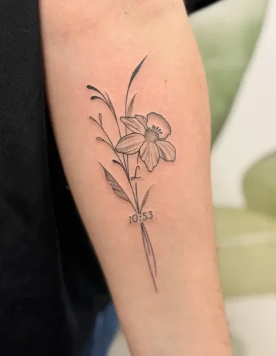 tatouage floral iris en style fine line sur l'avant bras intérieur d'une femme - Tattoo chez L